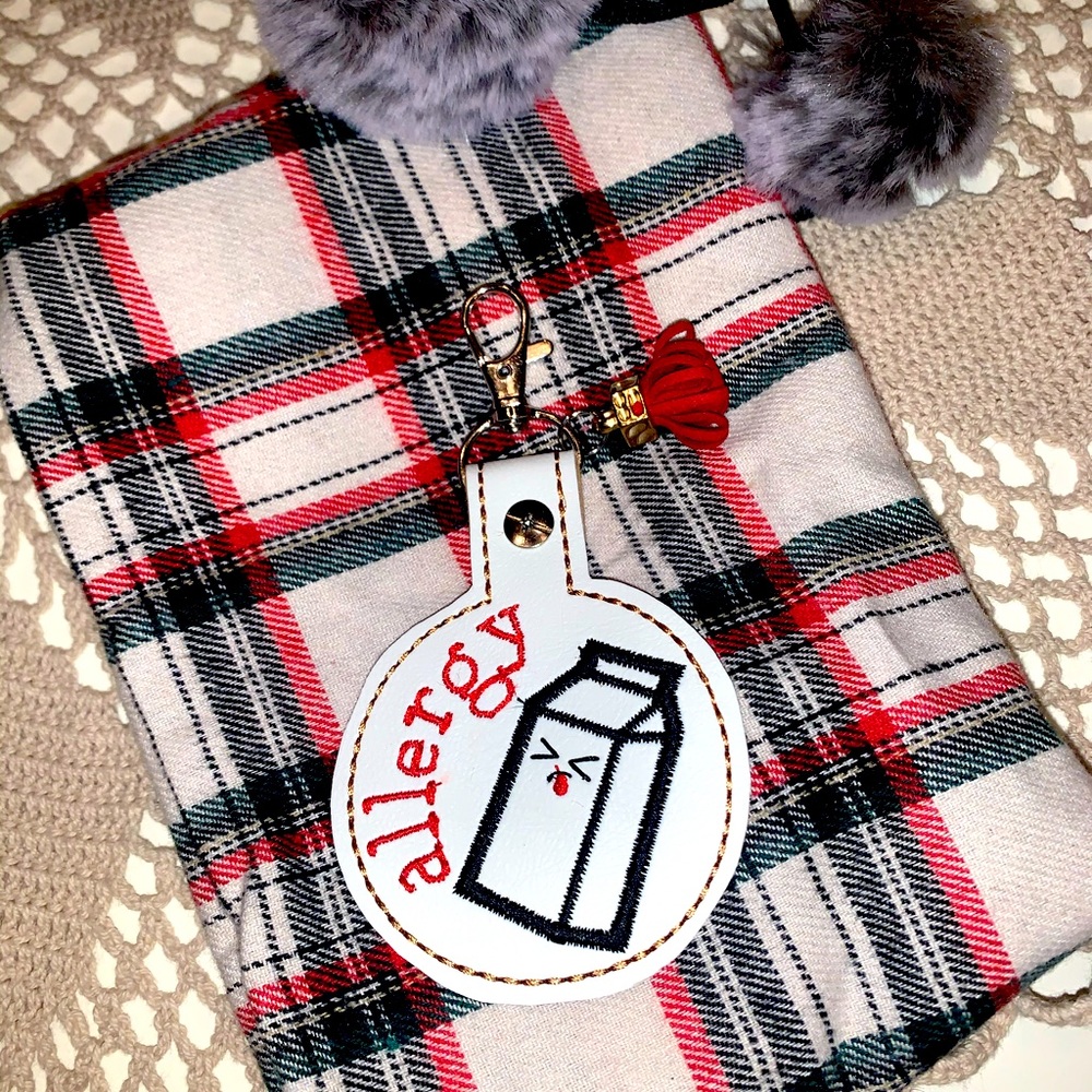 Dairy allergy backpack or purse tag . Clips on , wipe clean . Kids alert tag .
